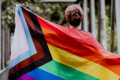 Man holding LGBT+ flag